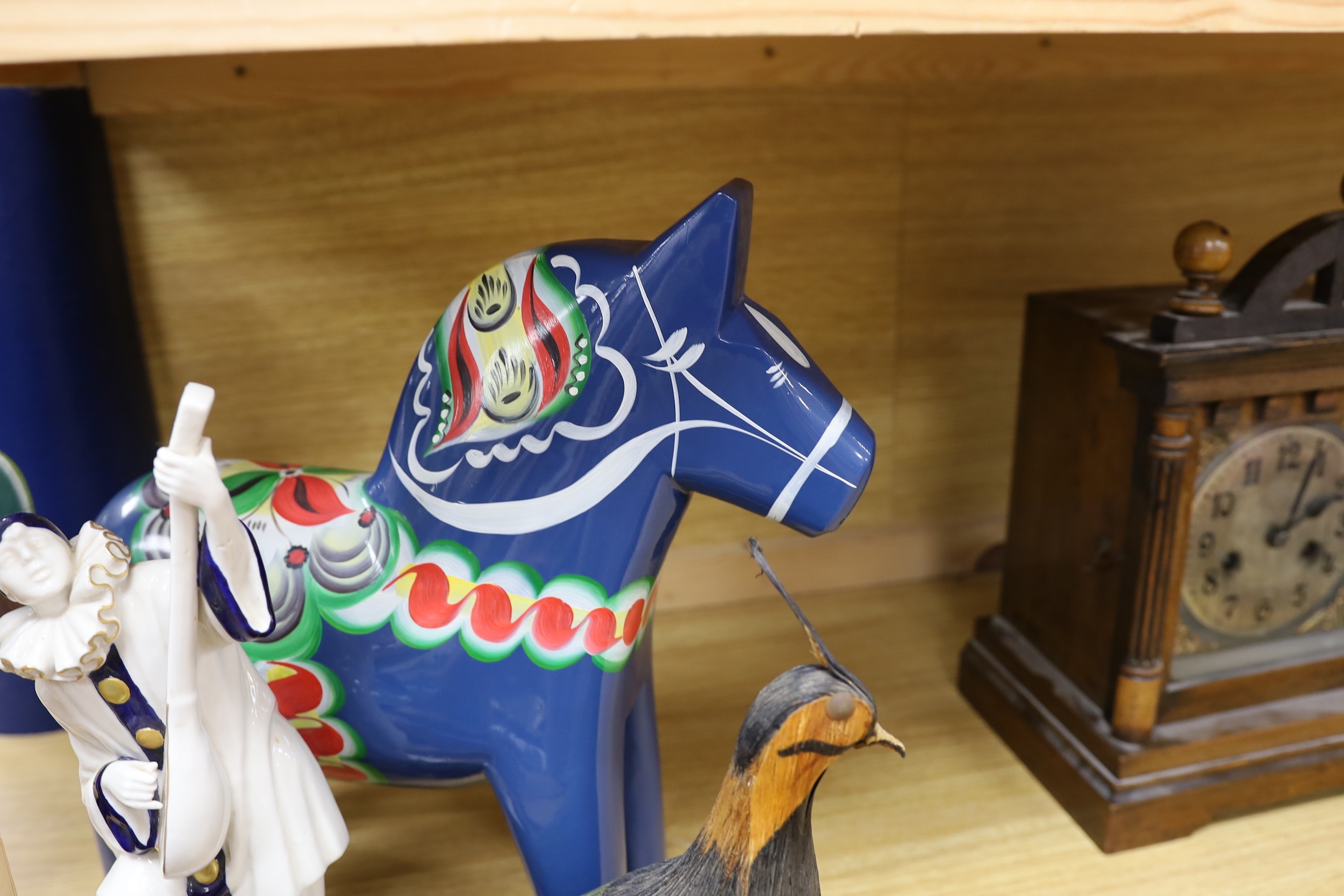 A Spanish porcelain model of Pierrot playing a mandolin, blue and gilt decoration, H29, a Swedish painted wood horse and decorative items